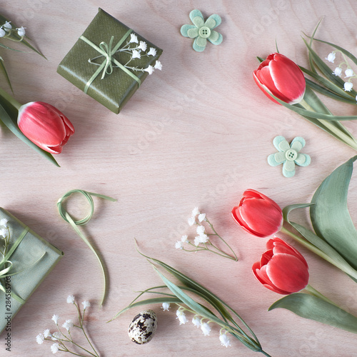 Overhead view of light wooden table with springtime decorations, photo