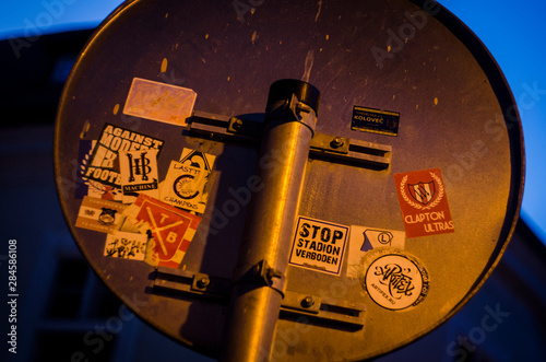 road sign with stickers