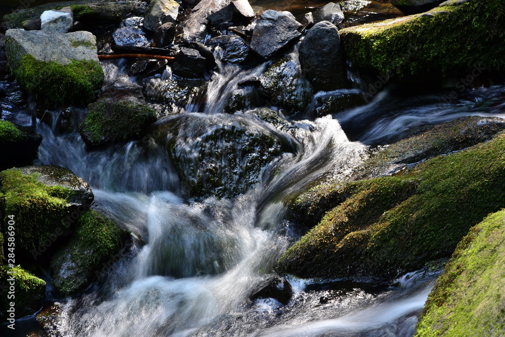 Detail of the river water flow in stones Detail of the river water flow in stones
