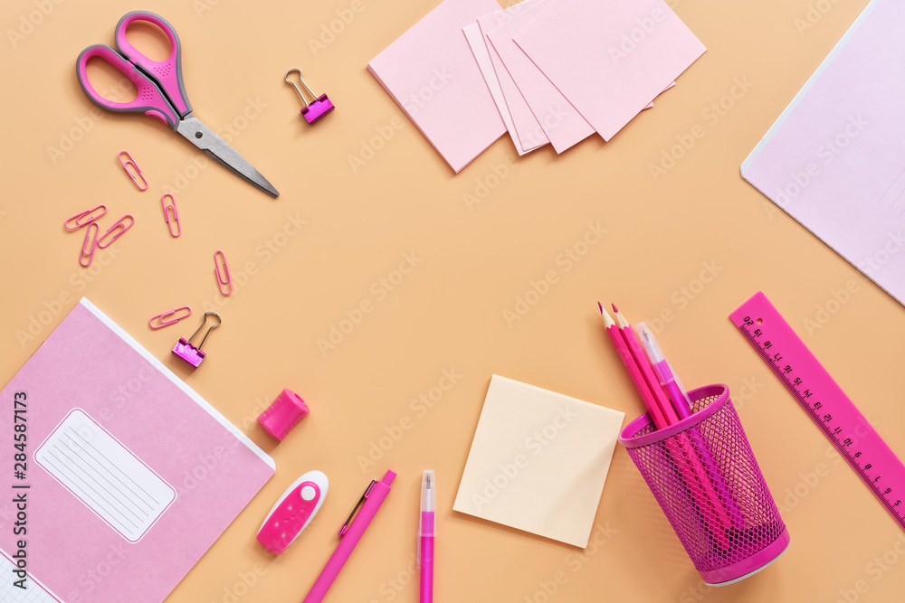 Flat lay pink stationery and school supplies on a pastel yellow background. Back to school. View from above, copy space. Flat lay pink stationery and school supplies on a pastel yellow background. Back to school. View from above, copy space.
