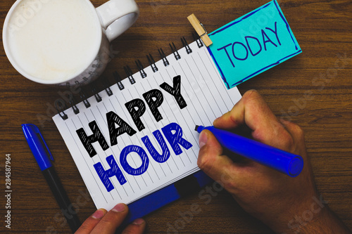 Word writing text Happy Hour. Business concept for Spending time for activities that makes you relax for a while Man holding marker notebook clothespin reminder wooden table cup coffee photo