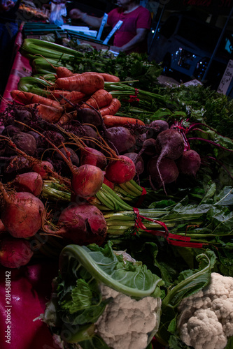 Radishes, carrots & celery. vibrant reds and greens, laid out at the farmers market for patrong.