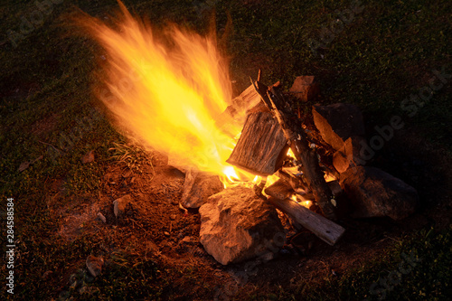 Bonfire on the field at night. Warm.