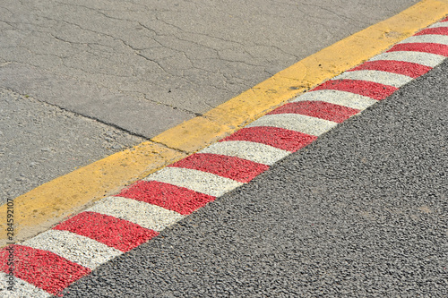 red barrier line on asphalt, restricted security area © FMUA