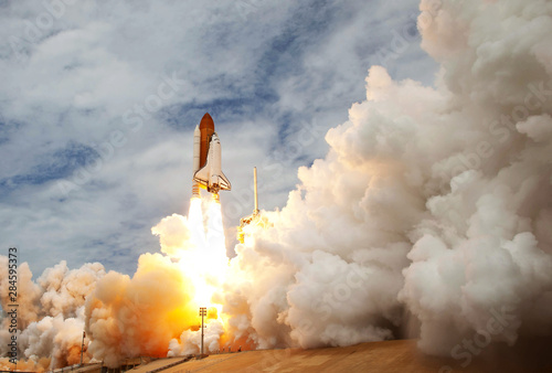 Fototapeta Naklejka Na Ścianę i Meble -  The launch of the space shuttle. With fire and smoke. Against the background of the starry sky.  Elements of this image were furnished by NASA