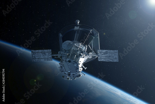 Fototapeta Naklejka Na Ścianę i Meble -  Large space satellite in space above the earth.  Elements of this image were furnished by NASA