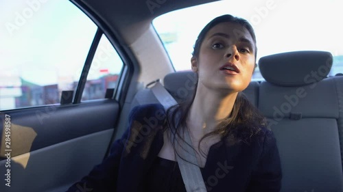 Unhappy female passenger telling amateur driver fastest route, poor service photo