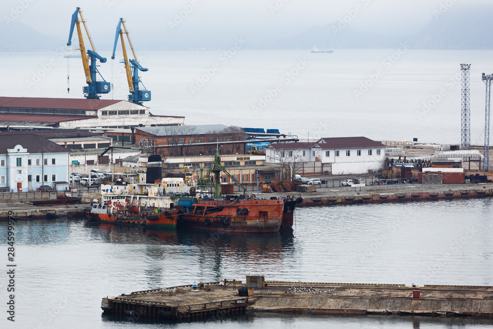 Coal terminal in the sea trading port of the sea city of Nakhodka. Coal collapse on the coast of a large city.