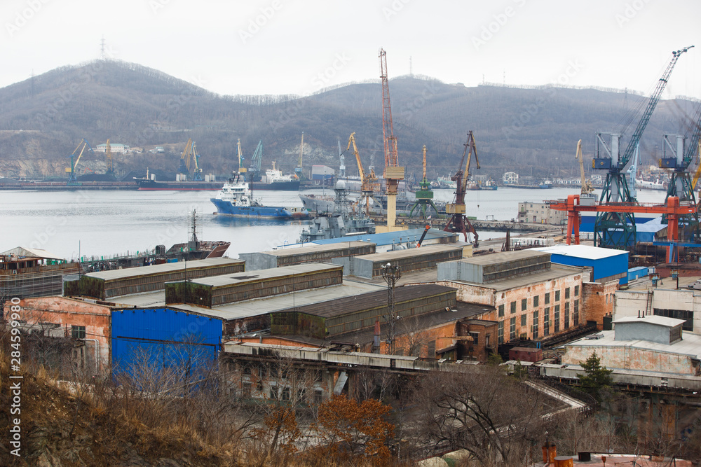 Coal terminal in the sea trading port of the sea city of Nakhodka. Coal collapse on the coast of a large city.