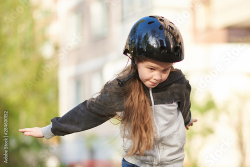 Little beautiful girl falls off a skateboard
