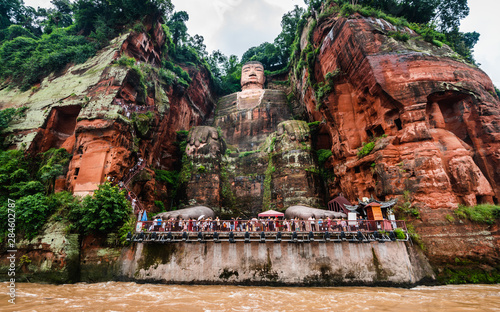Wide angle view of Leshan Giant Buddha or Dafo from river boat in Leshan China photo