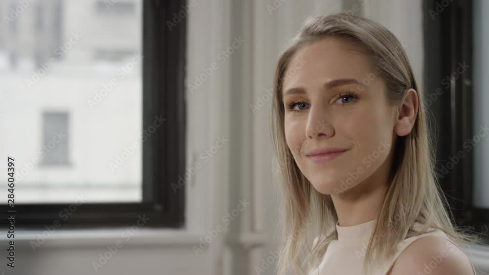 Beautiful young blonde woman looks confidently at the camera Beautiful young blonde woman looks confidently at the camera
