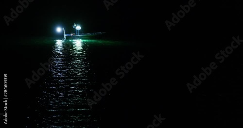 Fishing vessel with lights at night sea near Sibenik in Croatia