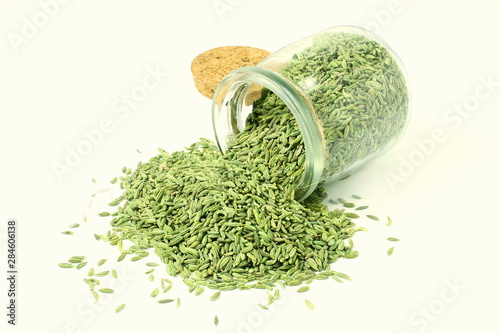 dried fennel seeds or Saunf herb in bottle isolated on white, top view  photo