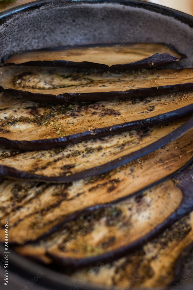 Baked aubergine, eggplant. Roasted with spices on plate. Vegan food Baked aubergine, eggplant. Roasted with spices on plate. Vegan food
