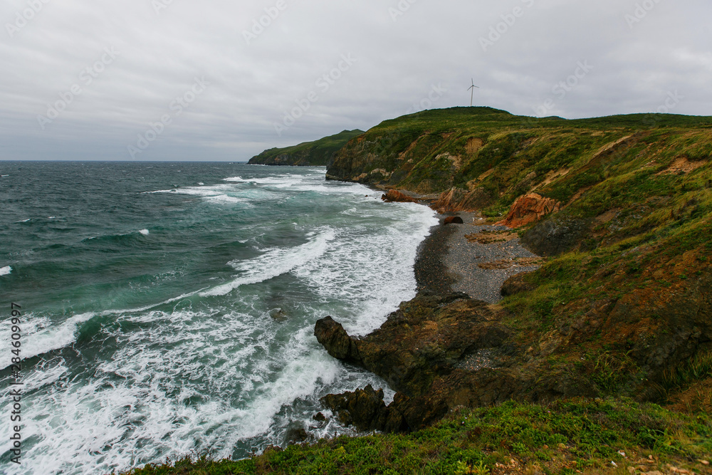 Beautiful sloping coast of the island during a severe storm