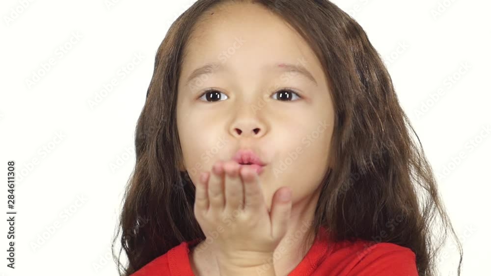 Close-up girl making air kiss at white background. Slow motion Close-up girl making air kiss at white background. Slow motion