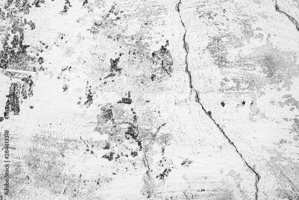 Fototapeta premium Texture of a concrete wall with cracks and scratches which can be used as a background