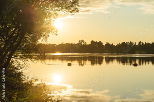 The orange light of a beautiful sunset is reflected in the eagle creek at Marinette,WI. photo