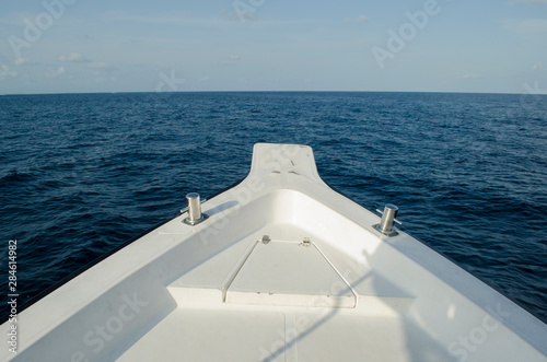 Exploring Blue Sea on White Boat and moving towards Horizon