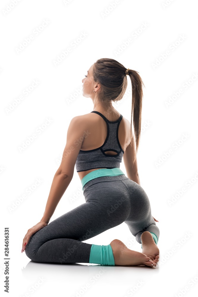 Obraz premium Slim girl in sportswear exercising isolated shot