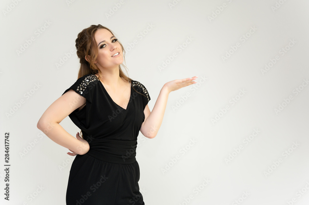 Photo waist-length portrait of a pretty brunette woman girl with long beautiful curly hair on a white background in a black dress. Talking in different poses. Standing facing the camera. Photo waist-length portrait of a pretty brunette woman girl with long beautiful curly hair on a white background in a black dress. Talking in different poses. Standing facing the camera.