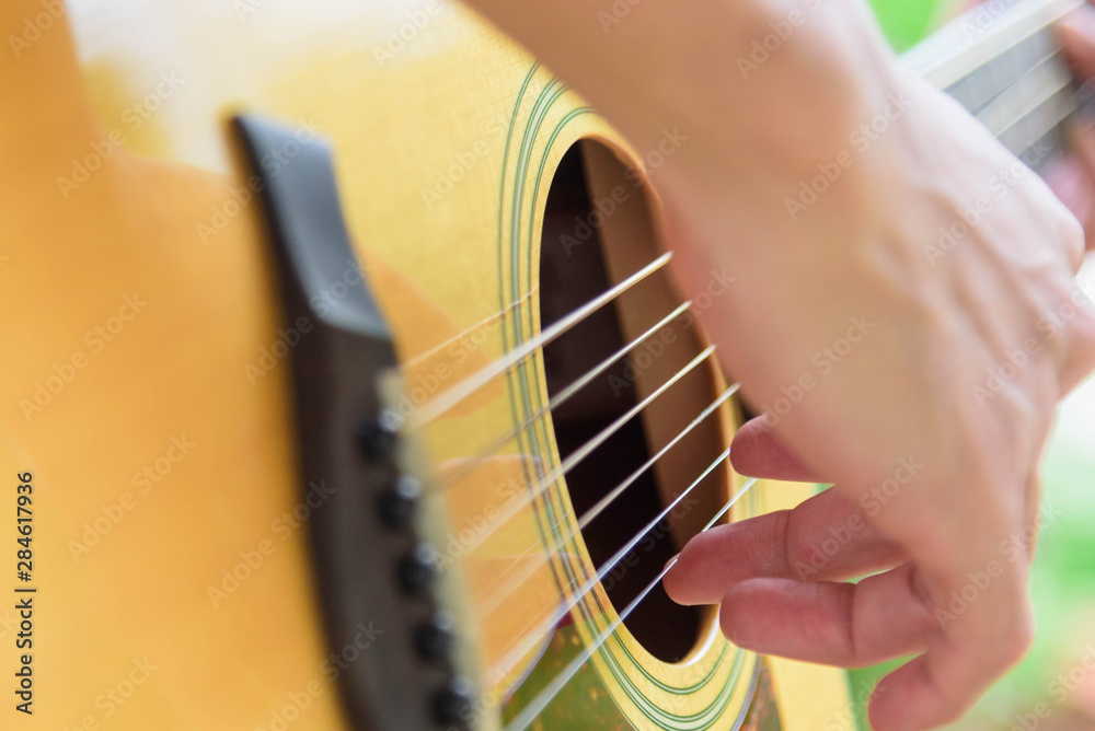 Fototapeta premium Musician Playing acoustic guitar in the park