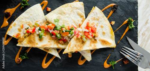 Quesadillas with salsa mexican Sauce serve with Cheese photo