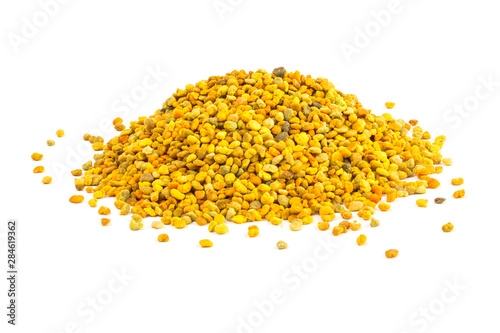 a small heap of bee pollen anules isolated on white background