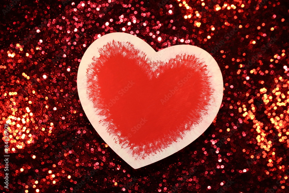 beautiful red heart on red shiny background