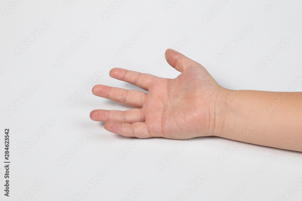 Selective focus hand of little Asian boy and fingers symbols in one two victory thum up and begging on white isolated background Selective focus hand of little Asian boy and fingers symbols in one two victory thum up and begging on white isolated background