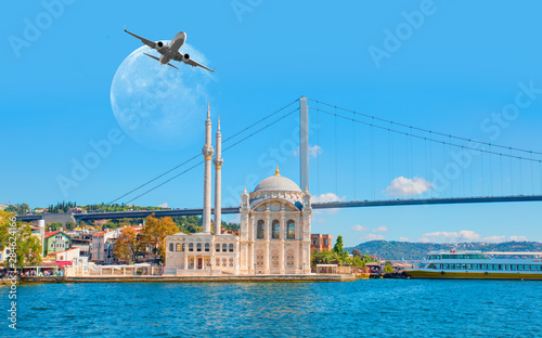 Fototapeta Naklejka Na Ścianę i Meble -  Airplane flying over Ortakoy Mosque with full moon - Istanbul, Turkey 