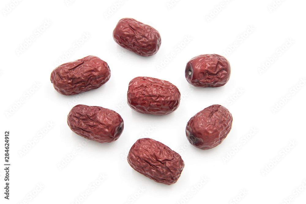 Close-up of a small pile of Chinese red dates on a white background Close-up of a small pile of Chinese red dates on a white background