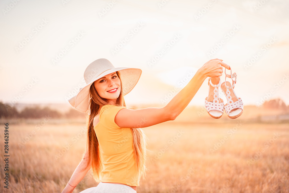 Portrait of young woman outdoors in a wheat field Portrait of young woman outdoors in a wheat field
