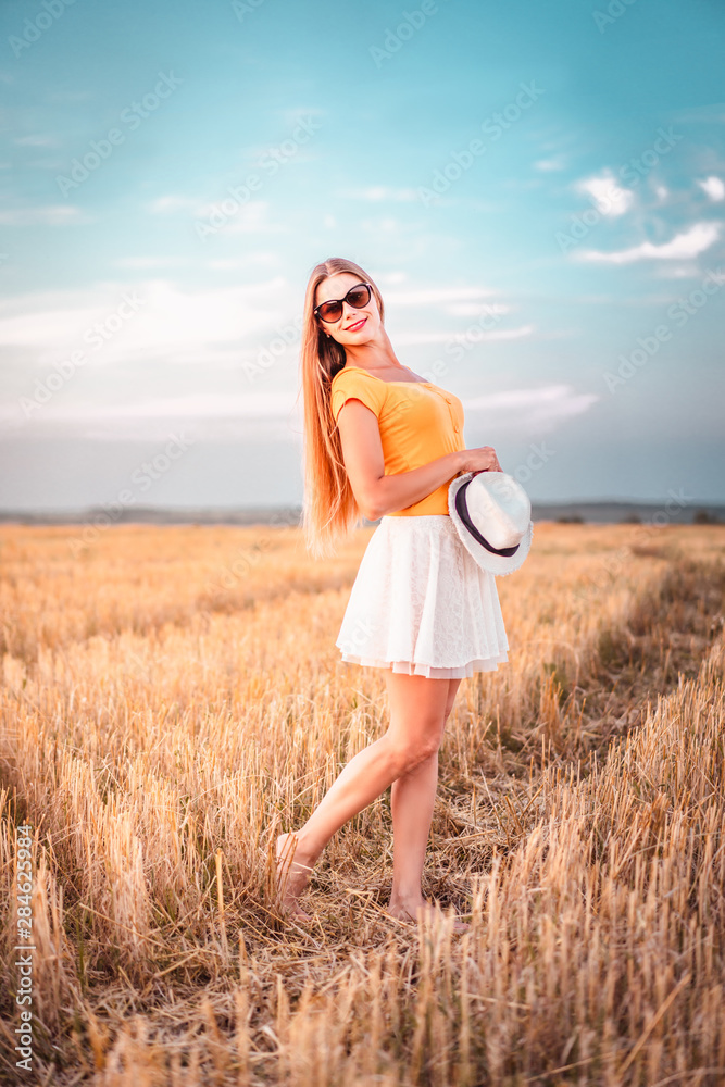 Portrait of young woman outdoors in a wheat field Portrait of young woman outdoors in a wheat field