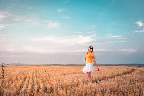 Portrait of young woman outdoors in a wheat field