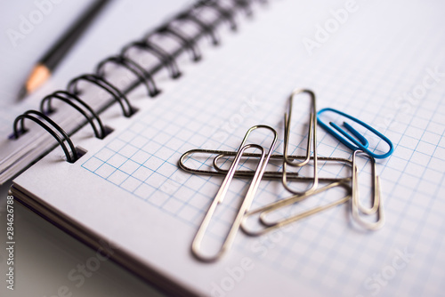 Notebook and paper clip on a white background