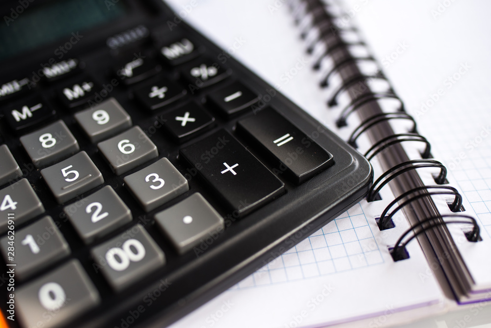 calculator and pen on a white background calculator and pen on a white background