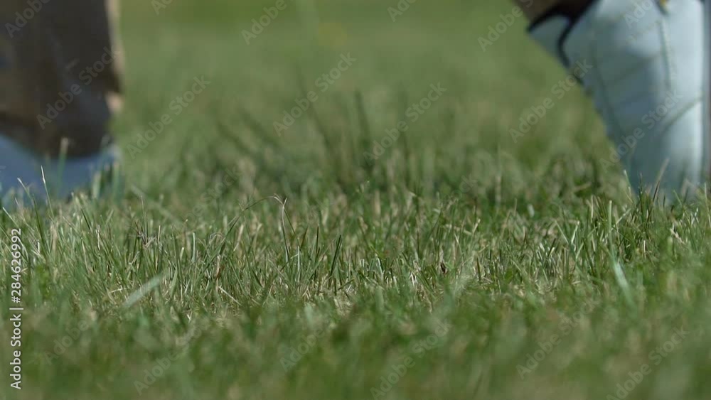 Golfer making driver shot hitting ball from tee box and slicing ground, slow-mo Golfer making driver shot hitting ball from tee box and slicing ground, slow-mo