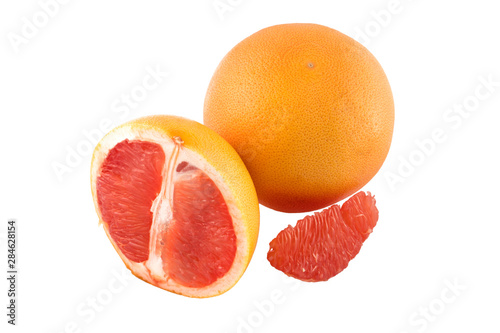 whole grapefruit and slices on a white background in isolation