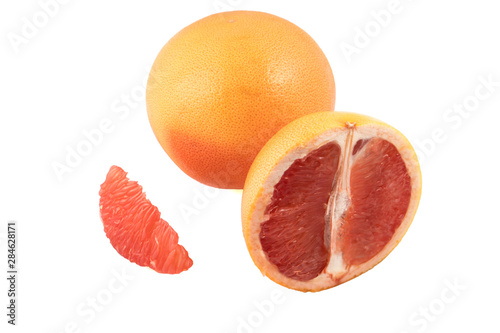 whole grapefruit and slices on a white background in isolation