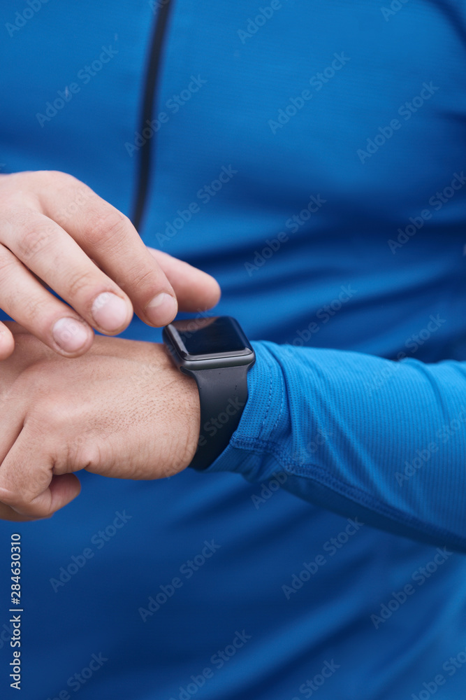 Male hands checking smart watch
