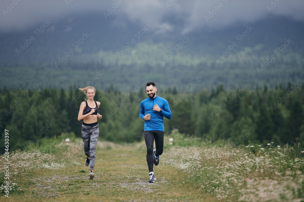 Trainer and female sportsman jogging outdoor Trainer and female sportsman jogging outdoor
