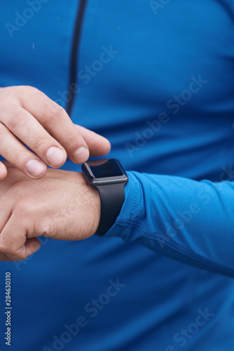 Male hands checking smart watch
