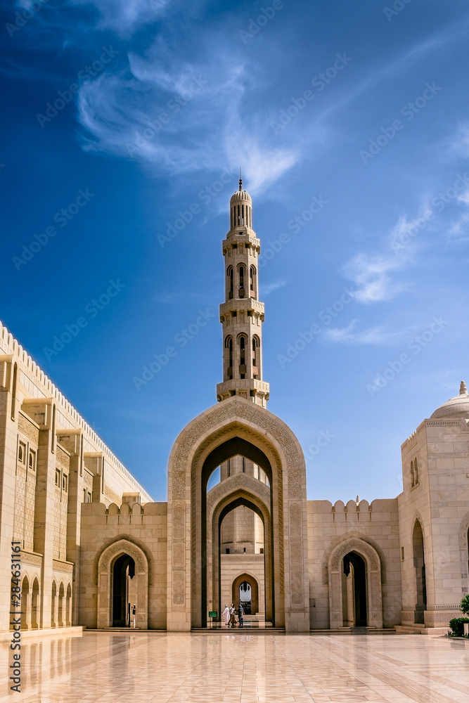 Muscat,Oman-22nd july 2019. Sultan Quaboos Grand Mosque minaret with beautiful clouds and blue sky, Islamic traditional religious architecture and landscape.