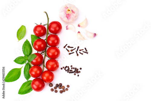 Top view of red       tomato cherry with green basil leaves and young garlic  spice  isolated on white background  Flat lay.