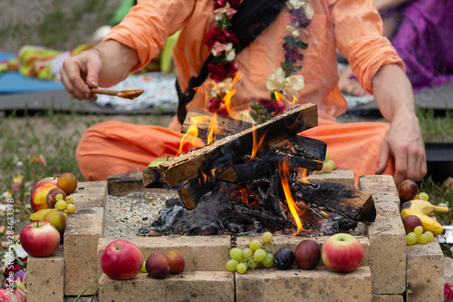 Hindu ritual with cooking and prayer reading photo