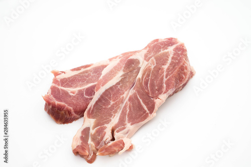 resh raw pork neck meat garlic pepper and rosemary isolated on white