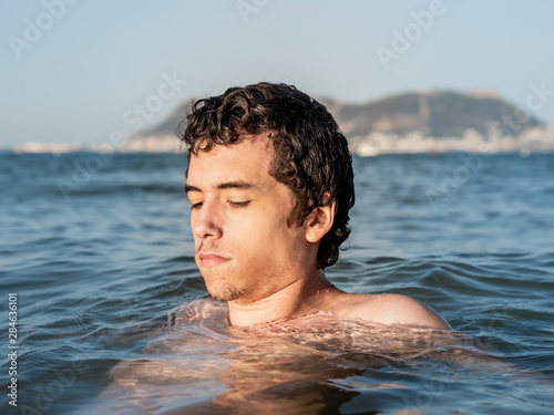 Young man relaxing and refreshing in the ocean
