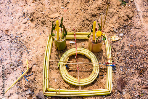 Bamboo symbol left on the ground as a shrine at a Buddhist Temple in a rural area of Cambodia photo